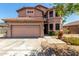 Two-story home with a neutral color scheme, well-maintained landscaping, and a two-car garage at 16527 N 71St Dr, Peoria, AZ 85382