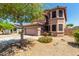 Two-story home with a neutral color scheme, well-maintained landscaping, and a two-car garage at 16527 N 71St Dr, Peoria, AZ 85382