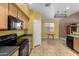 Functional kitchen design, black appliances, oak cabinets, and adjacent eat-in breakfast nook at 16527 N 71St Dr, Peoria, AZ 85382