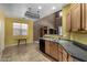 Functional kitchen design, black appliances, oak cabinets, and adjacent eat-in breakfast nook at 16527 N 71St Dr, Peoria, AZ 85382