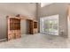 Spacious living room with high ceilings, natural light, and custom built-in shelving at 16527 N 71St Dr, Peoria, AZ 85382