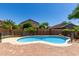 This backyard has a pool, brick patio, privacy wall, and mature landscaping at 16527 N 71St Dr, Peoria, AZ 85382