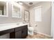 Well-lit bathroom with a mirror, single sink vanity, toilet, and window for a bright and clean space at 16632 W Jenan St, Surprise, AZ 85388