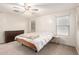 Cozy bedroom with white walls, a comfortable bed, and a ceiling fan at 16632 W Jenan St, Surprise, AZ 85388
