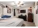 A bedroom space featuring neutral tones, a ceiling fan, and a TV for a modern and comfortable vibe at 16632 W Jenan St, Surprise, AZ 85388