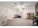 Versatile bonus room with carpet flooring, ceiling fan, and ample space for recreation and relaxation at 16632 W Jenan St, Surprise, AZ 85388