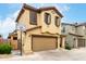 Charming two-story home featuring a two-car garage, tan stucco, and decorative shutters at 16632 W Jenan St, Surprise, AZ 85388