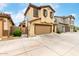 Charming two-story home featuring a two-car garage, tan stucco, and decorative shutters at 16632 W Jenan St, Surprise, AZ 85388