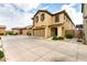 Charming two-story home featuring a two-car garage, tan stucco, and decorative shutters at 16632 W Jenan St, Surprise, AZ 85388