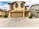 Charming two-story home featuring a two-car garage, tan stucco, and decorative shutters at 16632 W Jenan St, Surprise, AZ 85388