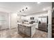Modern kitchen with white cabinets, stainless steel appliances, and a wooden island with granite countertops at 16632 W Jenan St, Surprise, AZ 85388