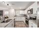 Bright kitchen features stainless appliances, granite counters, white cabinets, and a large stainless sink at 16632 W Jenan St, Surprise, AZ 85388