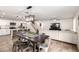 Open-concept living room and kitchen featuring a wooden dining table and a cozy sectional couch at 16632 W Jenan St, Surprise, AZ 85388