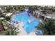 Community pool aerial view features beach entry, splash pad, lap pool and lounge seating at 16934 W Bronco Trl, Surprise, AZ 85387