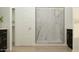 Modern bathroom with a sleek glass-enclosed shower, dark cabinets, and neutral tiling creating a spa-like experience at 16934 W Bronco Trl, Surprise, AZ 85387