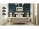 Stylish bedroom showcasing a blue accent wall, upholstered bed, modern lighting, and tasteful decor at 16934 W Bronco Trl, Surprise, AZ 85387