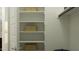 Spacious closet with open shelving, perfect for organizing clothes and accessories in a tidy and accessible manner at 16934 W Bronco Trl, Surprise, AZ 85387