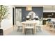 Stylish dining area showcasing a modern table setting, elegant lighting, and seamless flow to the living space at 16934 W Bronco Trl, Surprise, AZ 85387
