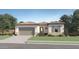 Charming one-story home showcasing desert landscaping, an attached two-car garage, and a beautiful tile roof at 16934 W Bronco Trl, Surprise, AZ 85387