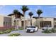 A modern home with a well-manicured front yard and a circular driveway at 16934 W Bronco Trl, Surprise, AZ 85387