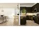 Modern kitchen with dark cabinetry, sleek countertops, and an open layout perfect for entertaining and Gathering gatherings at 16934 W Bronco Trl, Surprise, AZ 85387