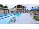 Community lap pool features lounge seating, shaded eating areas and spacious pool deck at 16934 W Bronco Trl, Surprise, AZ 85387