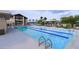 Community lap pool features lounge seating, shaded eating areas and spacious pool deck at 16934 W Bronco Trl, Surprise, AZ 85387