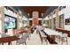 A spacious lounge area with a bar, dining tables, and large-screen televisions at 16934 W Bronco Trl, Surprise, AZ 85387