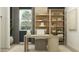Stylish home office with a modern desk, chic shelving, and comfortable seating offering an inspiring and productive workspace at 16934 W Bronco Trl, Surprise, AZ 85387