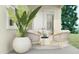 Serene patio showcasing comfortable seating, an outdoor rug, and vibrant greenery, creating a peaceful retreat for relaxation at 16934 W Bronco Trl, Surprise, AZ 85387