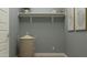 A well-organized storage space with a shelf, wicker basket, light wood flooring, and neutral-toned walls at 16934 W Bronco Trl, Surprise, AZ 85387