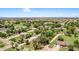 Picturesque neighborhood with lush greenery, mature trees, and a variety of single-Gathering homes under a bright blue sky at 17730 E Brooks Farm Rd, Gilbert, AZ 85298