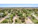Lovely neighborhood showcases an array of homes, green lawns, mature trees, and an open sky at 17730 E Brooks Farm Rd, Gilbert, AZ 85298