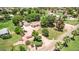 Expansive property featuring mature trees, well-maintained lawns, and a circular driveway leading to a charming single-story home at 17730 E Brooks Farm Rd, Gilbert, AZ 85298
