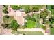 Overhead shot of a home with extended driveway, mature trees, and large grassy lawn at 17730 E Brooks Farm Rd, Gilbert, AZ 85298