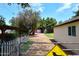 View of barn with large trees and lawn from behind the house at 17730 E Brooks Farm Rd, Gilbert, AZ 85298