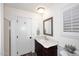 Bright bathroom featuring an ornate vanity with marble counter, a mirror, and modern fixtures at 17730 E Brooks Farm Rd, Gilbert, AZ 85298