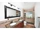 Stylish bathroom featuring dual sinks, granite counters, a framed mirror, and a glass-enclosed shower at 17730 E Brooks Farm Rd, Gilbert, AZ 85298