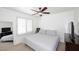Cozy bedroom with neutral carpet, a ceiling fan, and bright, natural light at 17730 E Brooks Farm Rd, Gilbert, AZ 85298
