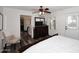 Bedroom with ceiling fan, shuttered window, wood-look flooring, and a white comforter at 17730 E Brooks Farm Rd, Gilbert, AZ 85298