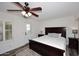Comfortable bedroom with a ceiling fan, a rug, and ample natural light at 17730 E Brooks Farm Rd, Gilbert, AZ 85298