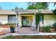 Inviting front entrance with a pergola, brick patio, and a cozy seating area at 17730 E Brooks Farm Rd, Gilbert, AZ 85298