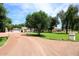 Charming home with a lush green lawn, mature trees, and a circular driveway at 17730 E Brooks Farm Rd, Gilbert, AZ 85298