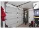 Garage interior with garage door, water heater, shelving, and ample storage space at 17730 E Brooks Farm Rd, Gilbert, AZ 85298
