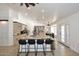 Open kitchen with a large center island, stainless appliances, and bright tile flooring throughout at 17730 E Brooks Farm Rd, Gilbert, AZ 85298