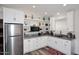 Modern kitchen with stainless steel appliances, marble countertops, and decorative shelving at 17730 E Brooks Farm Rd, Gilbert, AZ 85298