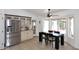Bright kitchen area with stainless steel appliances, ample storage, and an adjacent dining space at 17730 E Brooks Farm Rd, Gilbert, AZ 85298