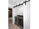 Efficient laundry room with modern stainless steel appliances and white cabinets at 17730 E Brooks Farm Rd, Gilbert, AZ 85298