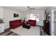 Cozy living room featuring red sofa and loveseat, with lots of natural light at 17730 E Brooks Farm Rd, Gilbert, AZ 85298