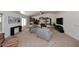Spacious living room with neutral carpet, fireplace, and an abundance of natural light at 17730 E Brooks Farm Rd, Gilbert, AZ 85298